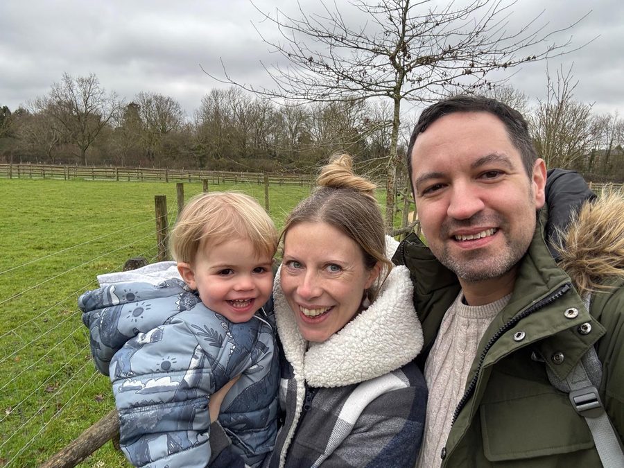 Richard smiling with his family outdoors